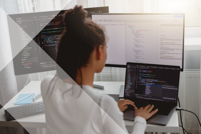 Woman working on laptop with two monitors, code is on the screen. The woman's back is to the camera. Iterable nodes overlay the lefthand side.