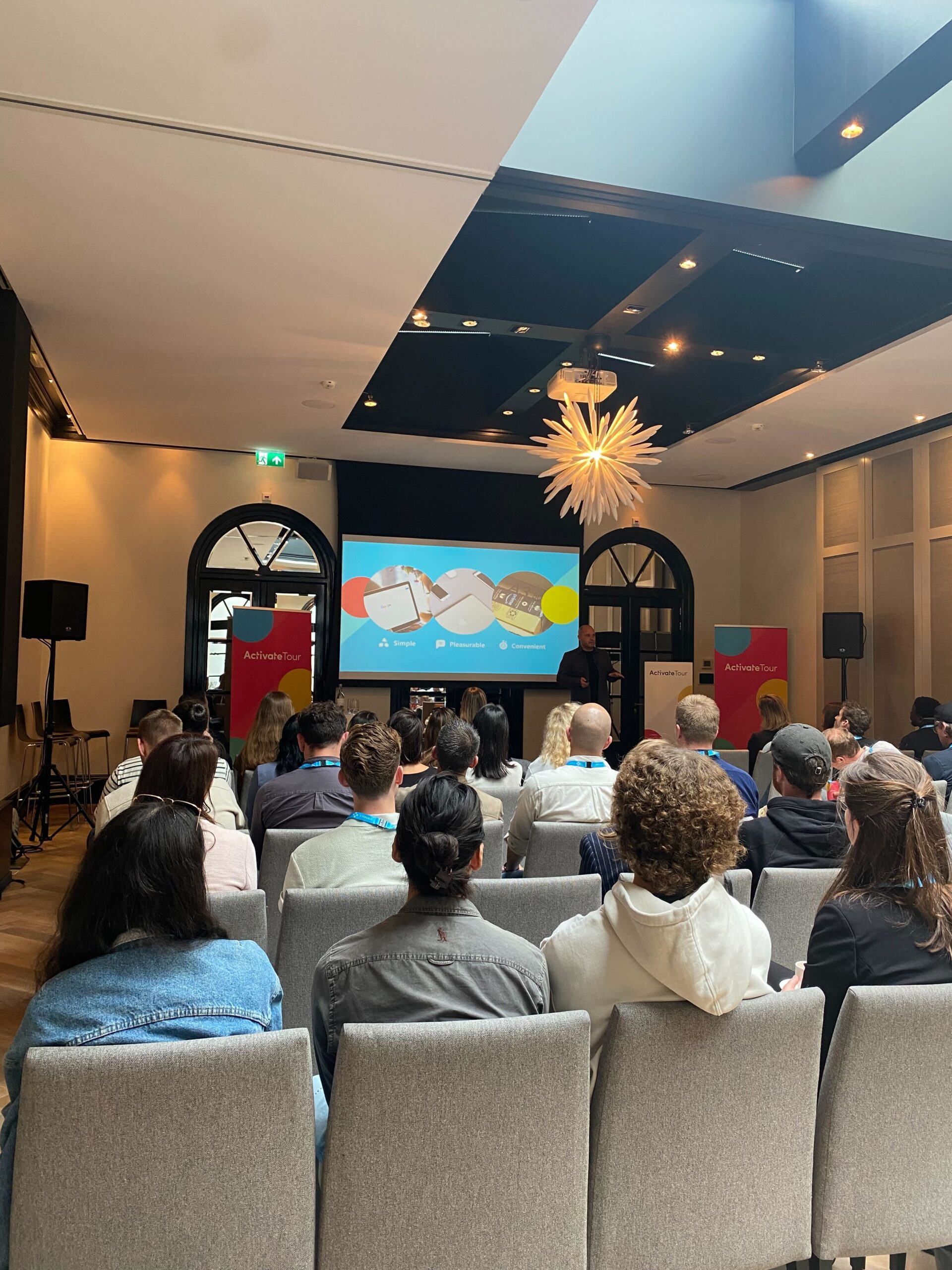 People seated watching a presentation.